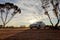 WESTERN AUSTRALIA - JULY 1, 2018: Travelling through the Australian outback with a white Toyota Corolla car in a beuatiful sunrise