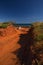 Western Australia â€“ Outback track with 4WD car going uphill from the ocean at Dampier Peninsula