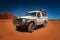 Western Australia â€“ Outback track with 4WD car on red sand at the ocean at Dampier Peninsula