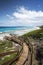 Western Australia â€“ rough coastline with stairway to the beach with blue sky