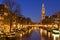 The Western Church and a canal in Amsterdam at night