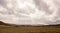 Western Plains Landscape with a Stormy Sky and Rocky Mountains