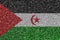 Western Sahara flag depicted on many small shiny sequins. Colorful festival background for party