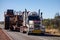 The Western Star road train with Oversize sign and extremely wide dumper truck