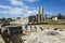 Western tourist standing among the ruins columns of Temple of Leto in Letoon Ancient City in village Kumluova, Turkey