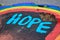 Westfield, NJ 04/17/20: Hope Written On A Tree Stump With A Rainbow To Bring Hope To People Who Suffer From Corona Virus/Covid-19