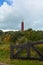 Westhoofd lighthouse in Ouddorp in the Netherlands, in a landscape and a fence
