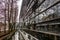 The Westlicher Stadtgrabenbach canal in downtown Munich, Germany, reflected in office windows