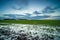 Wet arable land with puddles of rain during sunset