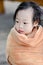 Wet Asian baby girl in brown towel