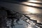 wet asphalt with reflections of the sun, creating a dazzling and eye-catching view