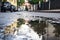 wet asphalt street after heavy rain storm with puddles and reflections