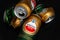 Wet beer cans. Crumpled empty beer cans with water drops on a dark background, top view. AMSTEL is a world famous brand from the