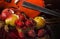 Wet berries of strawberries and fruit against the background of a violin