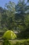 Wet camping yellow tent after the rain in forest