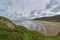 A wet day at Rhossili beach with lines of waves coming onto the shore in the windy conditions.