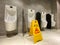 Wet floor alert sign during cleaning process in public toilet