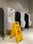 Wet floor cautious sign in public men toilet