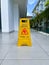 A wet floor sign placed next to the pool.