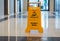 Wet floor warning sign standing in a corridor