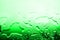 Wet glass surface in drops of water, green gradient, illustration of cood or cold bottle of beer, texture of spilled water