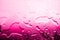 Wet glass surface in drops of water, pink gradient, hot water of high temperature heating, texture of spilled water