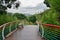 Wet hillside planked walkway in cloudy summer after rain