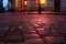 Wet illuminated by red light cobblestone street