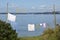 Wet linen on rope against the Japanese sea, city Bolshoy Kamen, Zvezda shipyard and  Zvezda crane. Hangan Peninsula.bay with pollu