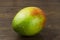 Wet mango ripe fresh red green yellow natural vitamins tropical life on wood