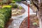 Wet paved trail going through a park on a rainy day; California