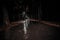 wet road with lanterns in the park after rain at night. gloomy dark landscape of a walkway in a city park. autumn deserted forest