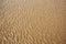 Wet sand texture. Sandy beach for background. Summer hollidays.