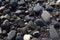 Wet, shiny stones on the shore of the sea, ocean, river or lake