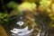 Wet texture of a waterdrop dropping on a water surface