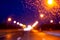 Wet track at night with the prospect of lighting lights along the road on a rainy night, blurred background