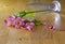 Wet tumbled purple flowers in a glass