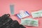 Wet wipe,hygienic mask,alcohol  hand gel .zip lock bag with part of woman`s hand bag  on pink background with copy space ,