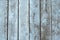 Wet wooden planks background with  light blue paint