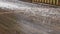 Wet wooden terrace after strong summer hail storm covered by white round frozen small hailstones. Unpredictable  summer weather.