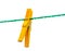 Wet yellow clothespin on a washing line