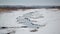 Wetland creek vanishing into the grasslands - on a snowy cold winter overcast day in the Crex Meadows Wildlife Area in Northern Wi