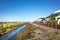 Wetlands and a row of residential houses. Skeleton Creek at Sanctuary Lakes, Melbourne, VIC Australia.