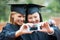 Weve finally graduated. Two young graduates taking a self-portrait at graduation.