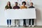 Weve got a message for the business world. Full length shot of a group of of young businesspeople holding a placard