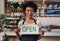 Weve just opened and would appreciate your support. Portrait of a young woman holding an open sign a cafe.