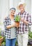 Weve never had the time to garden before. A happy senior couple busy gardening in their back yard.