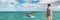 Whale watching boat tour tourist man panoramic banner background of humpback breaching flapping tail travel destination