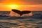 A whale waves its tail in the water at sunset, Generative AI