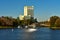 Wharf of Water taxis and forest with autumn colors, on Lake Buena Vista Hotel background.